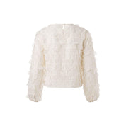 Semi-sheer blouse with 3D dots that create a playful texture. Round neckline with a back closure.